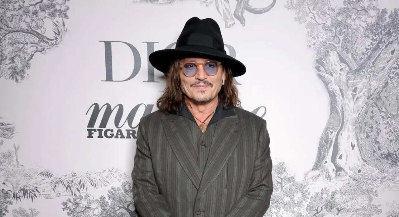 Johnny Depp Brings Dior And Spotlight To Spain’s Screen Tourism Gem 15 Johnny Depp wearing a hat and striped suit at a Dior promotional event