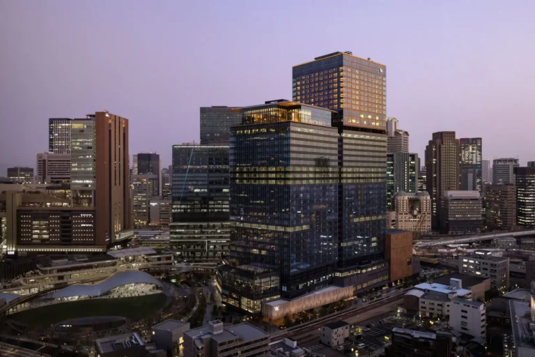 Luxury Travel 30 Waldorf Astoria Osaka exterior view at dusk with city skyline in the background