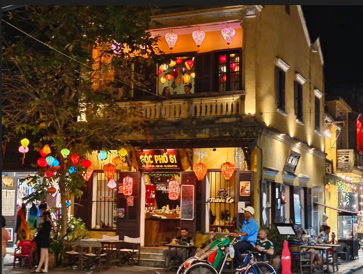 Vietnam’s Hoi An Turns On Its Magic At Night 11 Shophouse in Hoi An Old Town illuminated with colorful lanterns at night, with a trishaw passing by