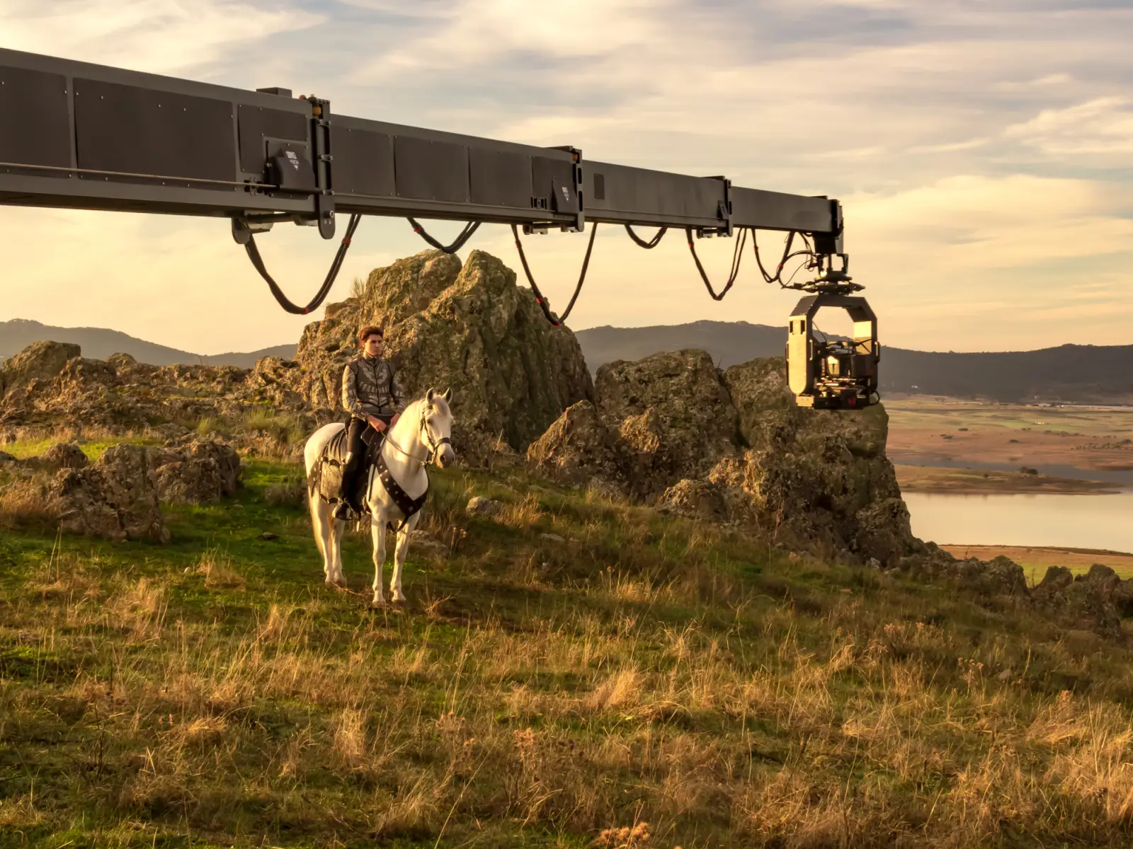 Actor on horseback being filmed by a crane-mounted camera at a scenic location in Cáceres, Spain