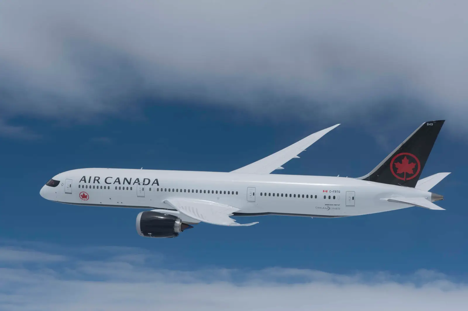 Air Canada Boeing 787 Dreamliner flying against a blue sky