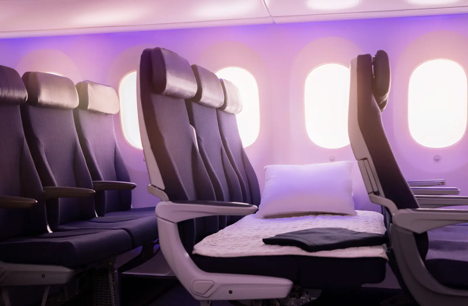 Air New Zealand Economy Skycouch with extended seating and soft lighting