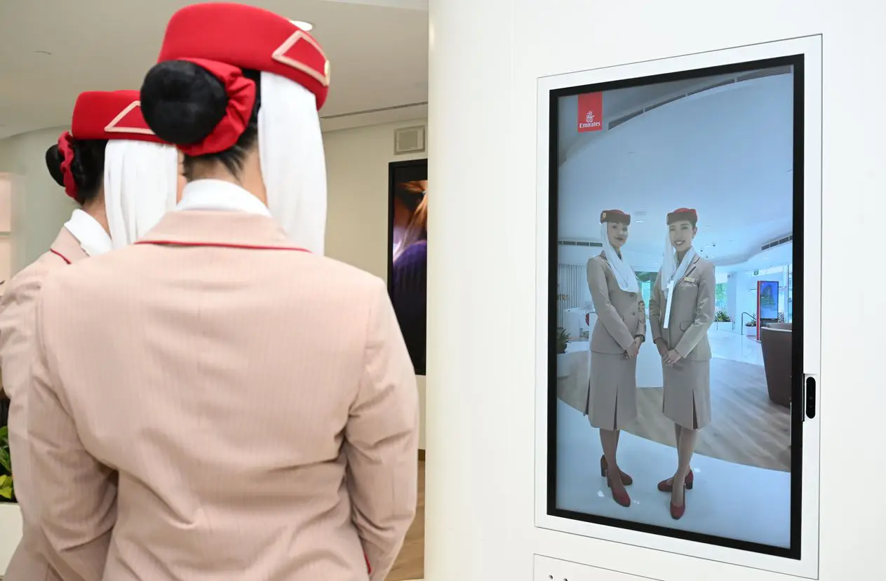 Emirates crew viewing their reflection on a digital selfie mirror at the Emirates World store in Singapore