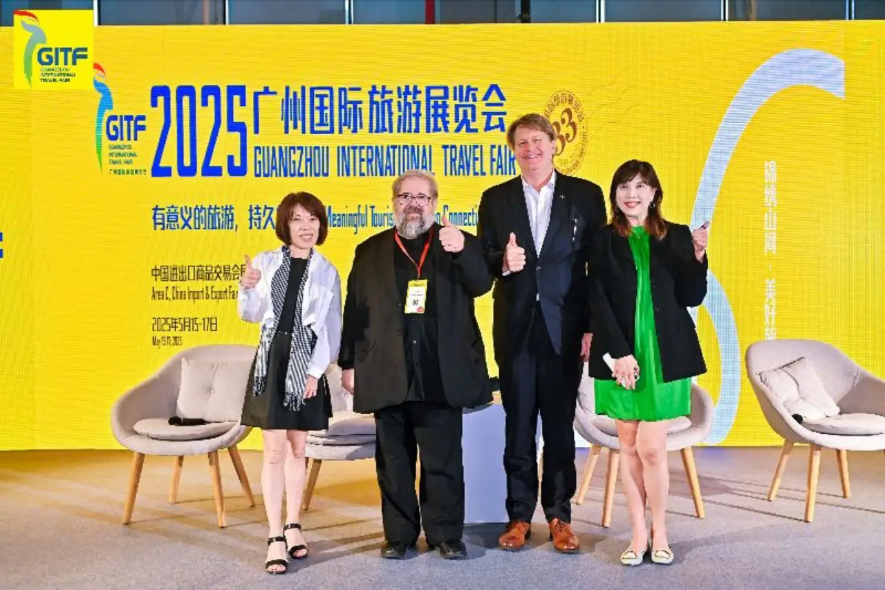 Group of tourism leaders posing with thumbs up at GITF 2025 stage in Guangzhou