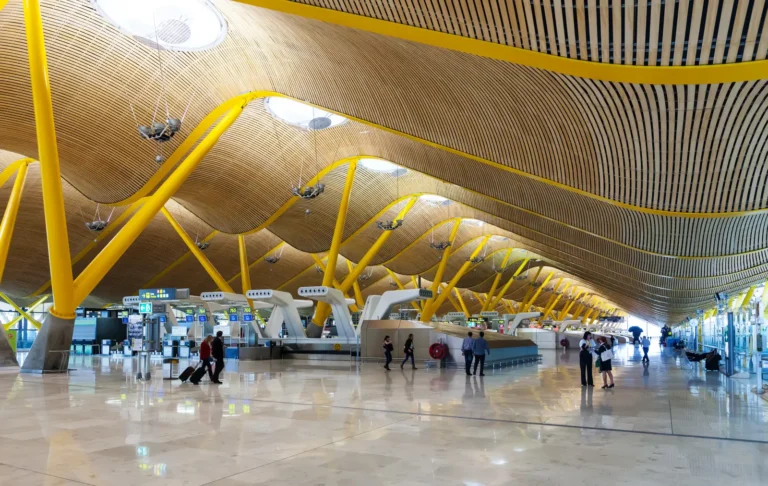 Spain Travel And Tourism News 7 Interior of Madrid-Barajas Airport Terminal 4 with yellow structural beams and modern check-in area