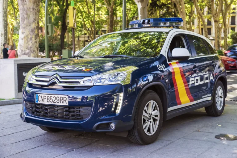 Spanish National Police car parked in Madrid with emergency number 091 displayed