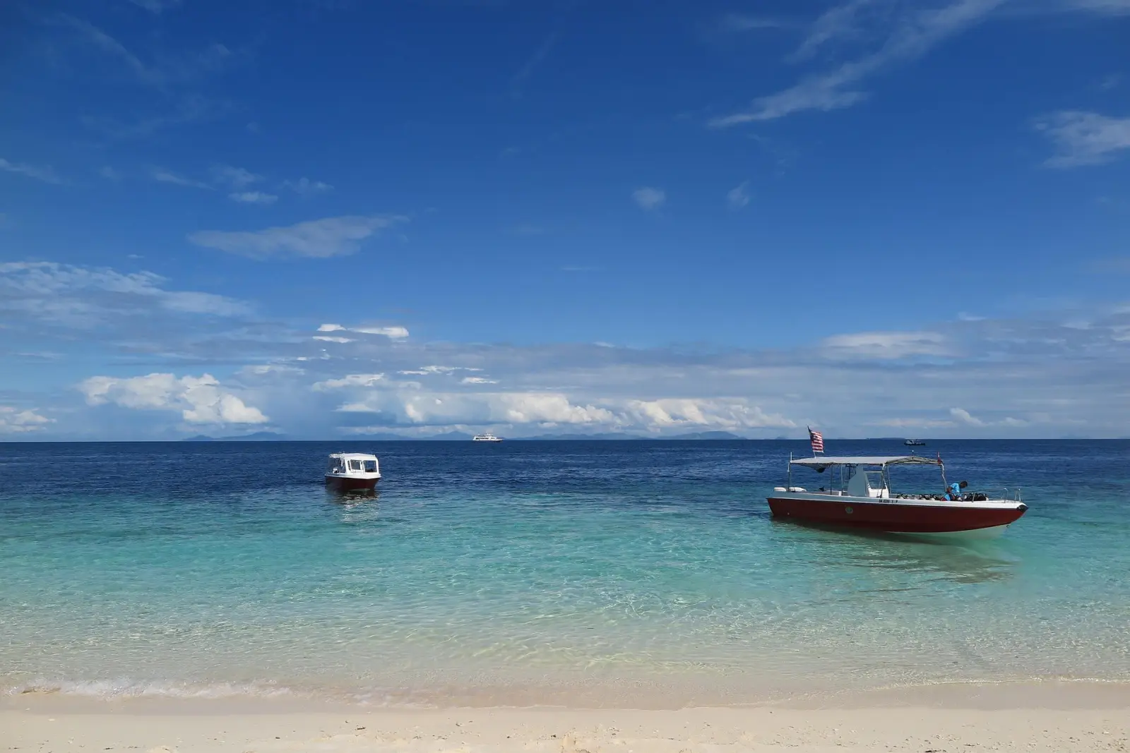 Awe-Inspiring Natural Wonders Of East Malaysia 5 Clear turquoise waters and dive boats near Sipadan Island, Malaysia