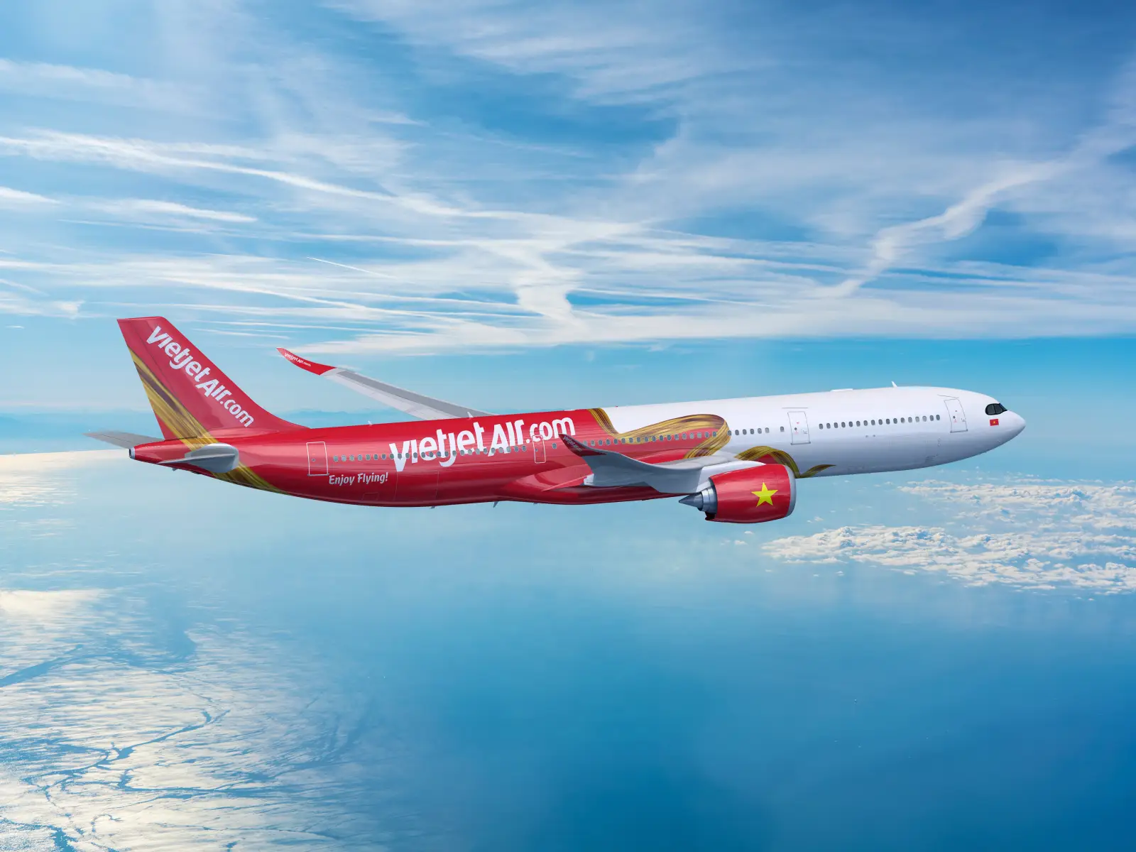 Vietjet Airbus A330 aircraft in flight above the clouds with clear blue skies