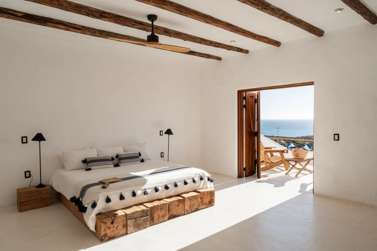 Ocean-view guest room at NEST Baja with natural wood elements and terrace