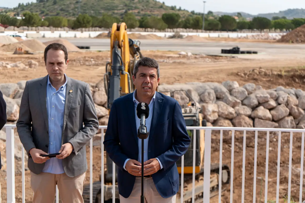 President Carlos Mazón speaks at Circuit Ricardo Tormo restoration site with José Morell standing nearby and construction equipment in the background