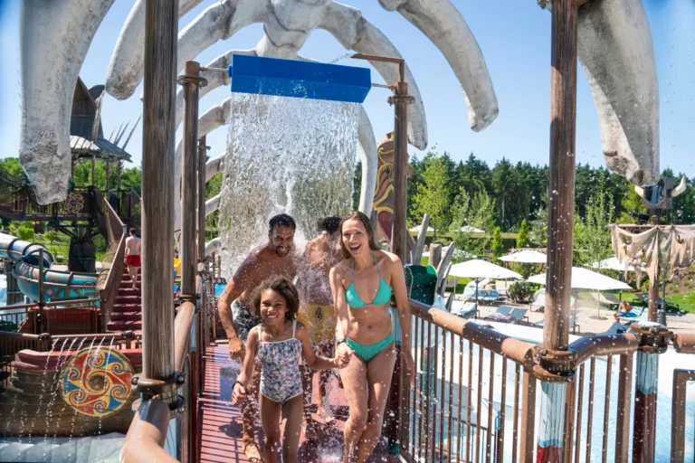 family of four enjoys hot summer day in a theme park in Germany with their swim suits
