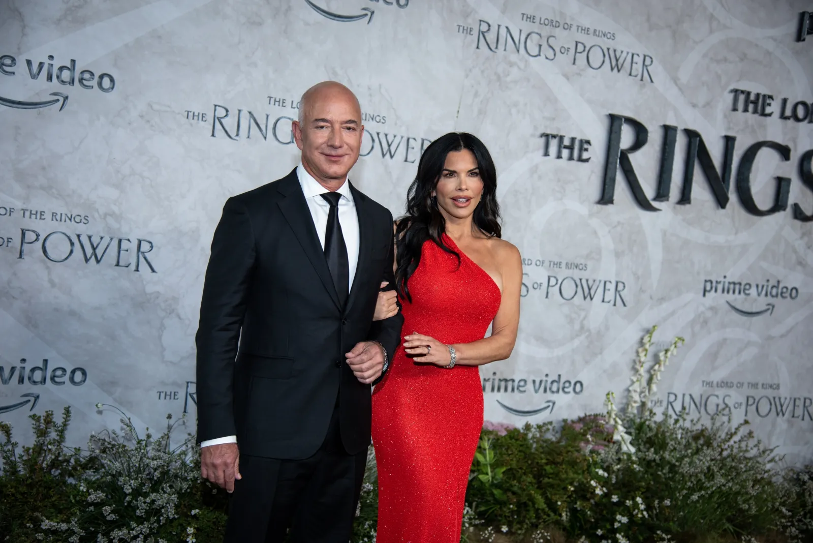 Jeff Bezos and Lauren Sánchez pose together at a red carpet event for “The Rings of Power”