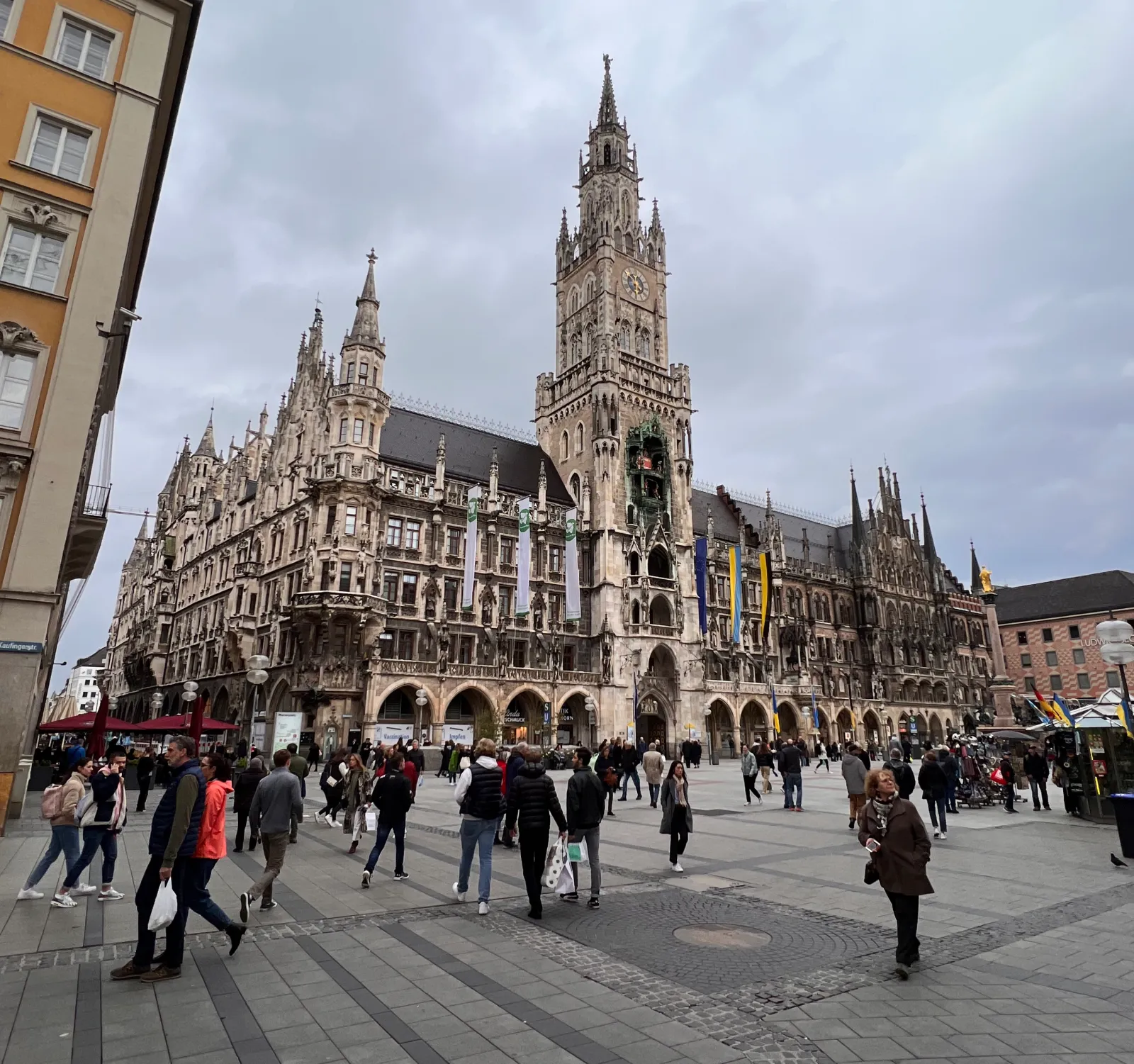 What Locals Know About Munich: Favorite Spots Tourists Skip 3 Crowds gather in front of Munich’s New Town Hall at Marienplatz on a cloudy day