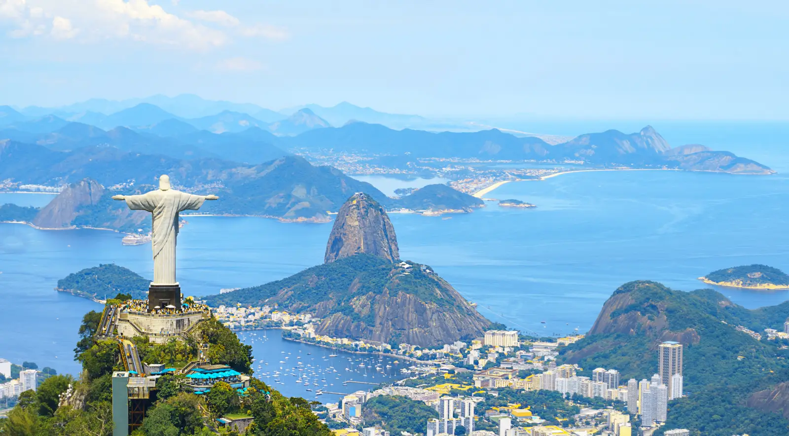 Best Places To Travel In 2026—National Geographic’s Top Picks 6 Aerial view of Christ the Redeemer overlooking Sugarloaf Mountain and Guanabara Bay in Rio de Janeiro, Brazil