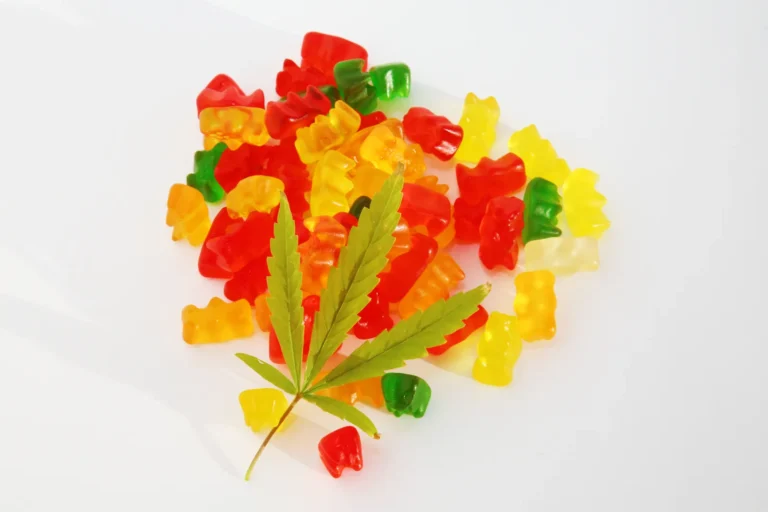 Colorful gummy bears with a cannabis leaf on top