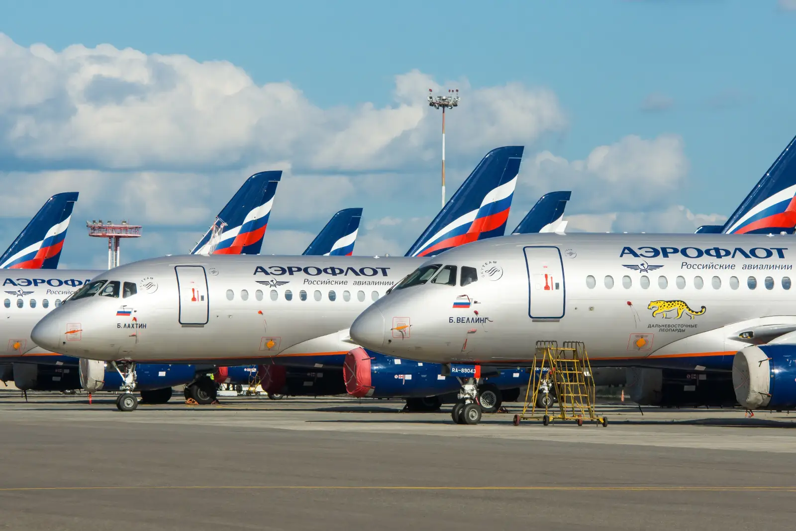Aeroflot aircraft parked at the airport with blue sky and clouds in the background.