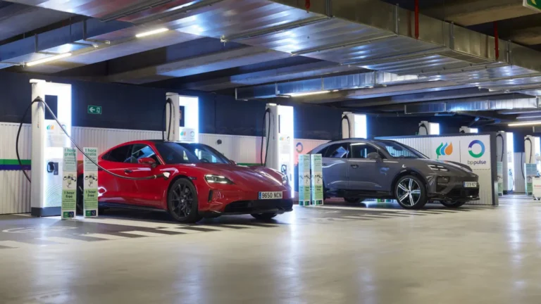 Technology 13 Red Porsche Taycan and gray Porsche Macan charging at ultra-fast EV stations in Madrid’s Nuevos Ministerios parking, part of Spain’s largest EV hub.
