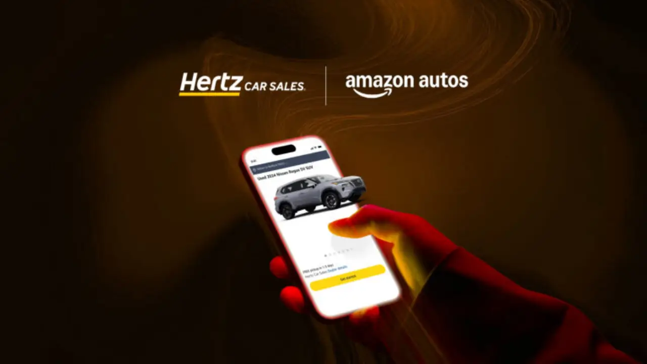 A person holding a smartphone showing a Hertz Car Sales vehicle listing, with Hertz Car Sales and Amazon Autos logos displayed above on a dark background.