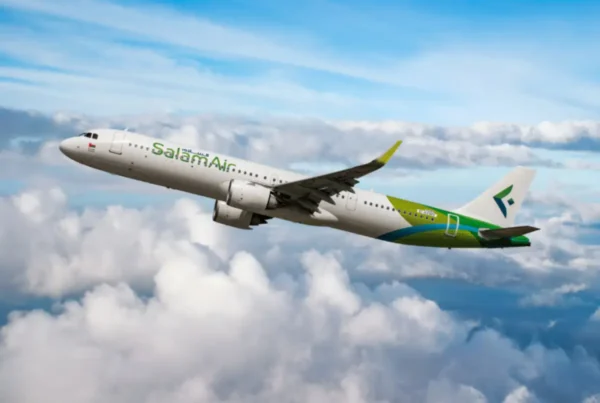 SalamAir Airbus A321neo in flight above the clouds, showcasing the airline’s green and blue livery with “SalamAir” branding on the fuselage.