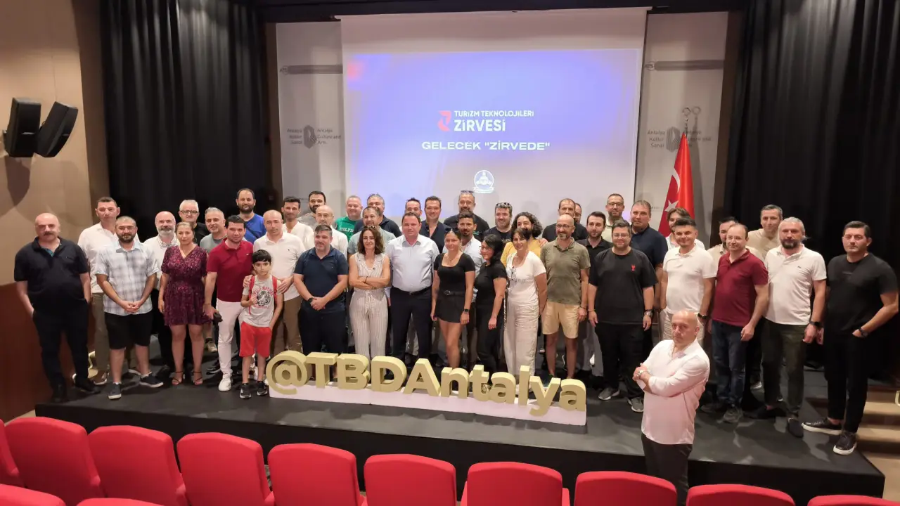 Antalya Gears Up For Global Tourism Technology Summit 2025 1 Group photo of participants at the Tourism Technology Summit launch event in Antalya, standing in front of a presentation screen with the summit logo and slogan.