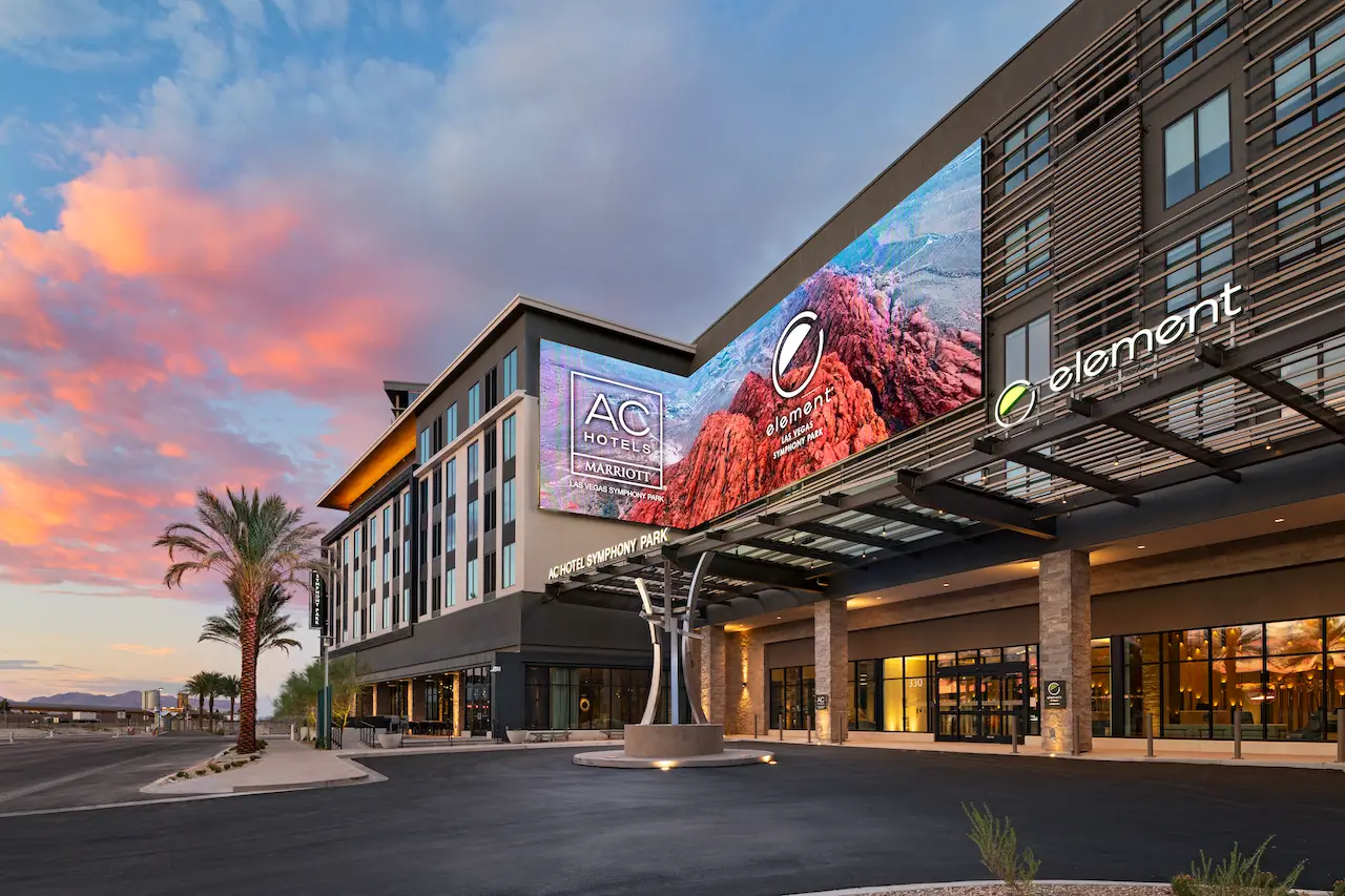 Exterior view of the dual-branded AC Hotel by Marriott and Element by Westin at Symphony Park in Las Vegas, showcasing signage and modern architecture.