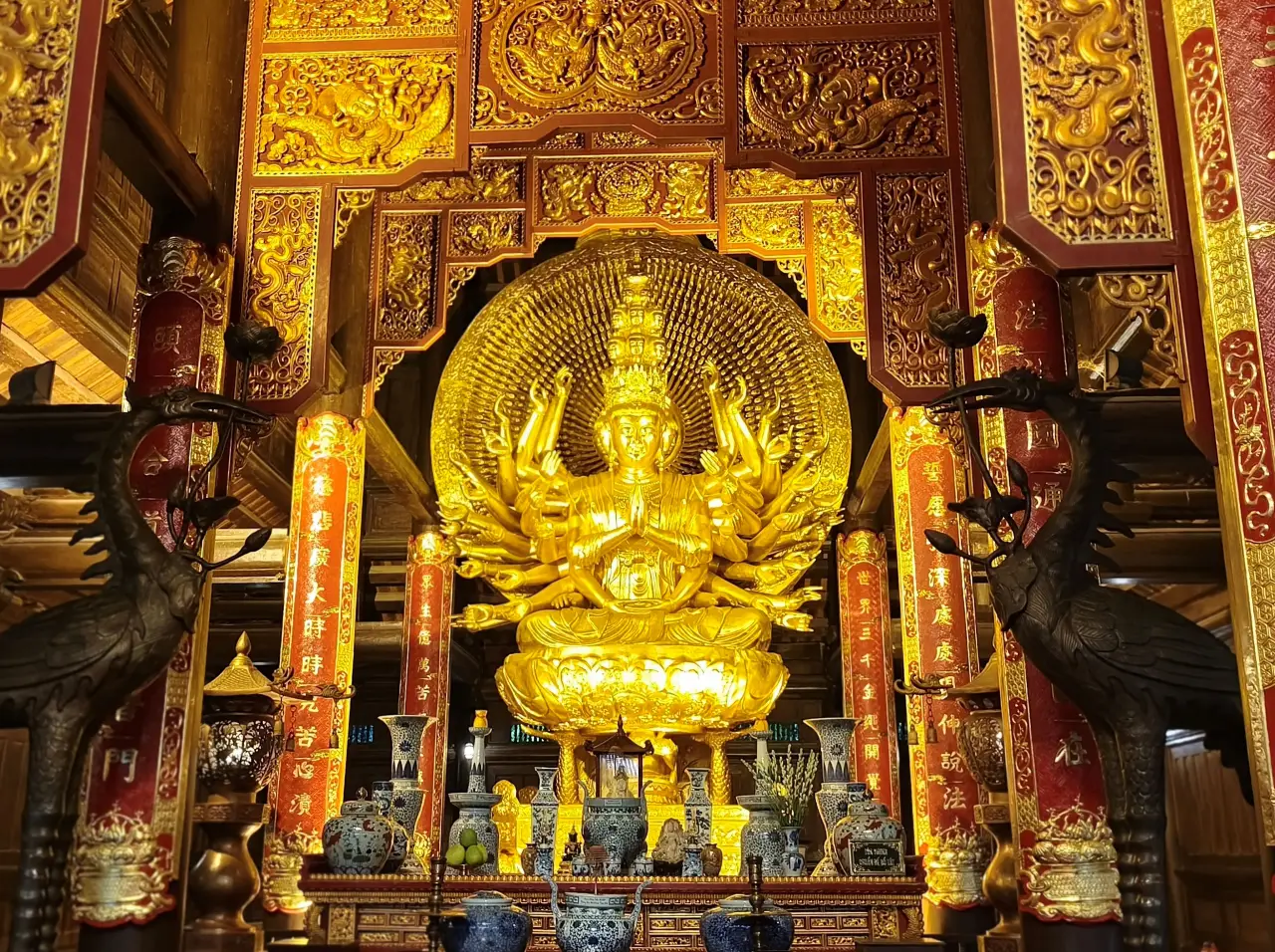 Golden Guan Yin statue with multiple arms inside Bai Dinh Pagoda, Vietnam