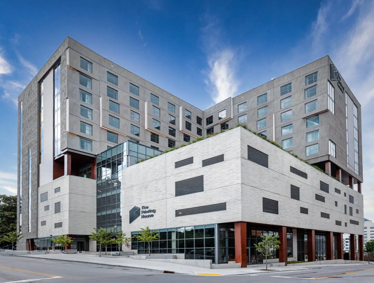 Exterior view of The Printing House Nashville, a modern Hilton Tapestry Collection hotel featuring a geometric façade and large windows.