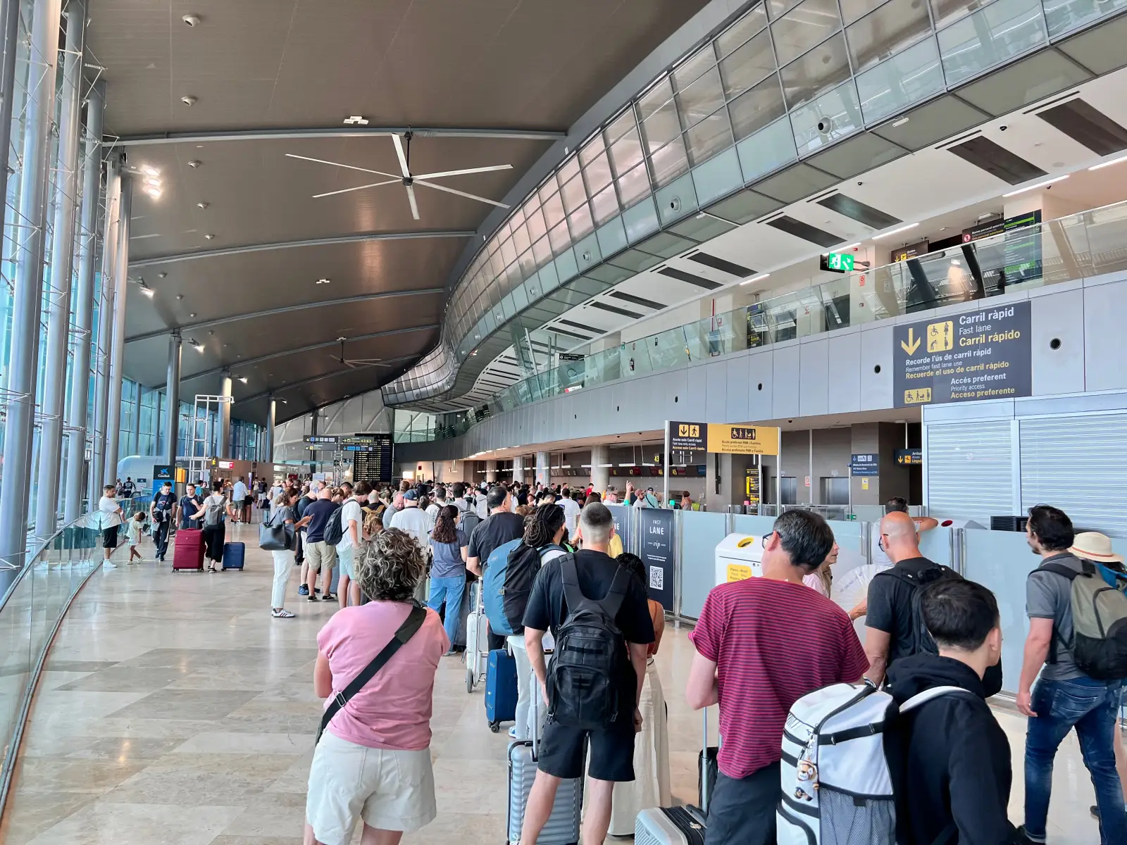 Passengers waiting in long check-in lines at the Valencia Airport terminal