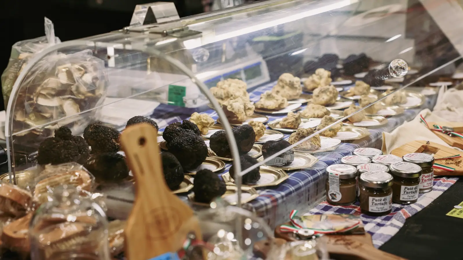 Italy Expects 146 Million Tourists In 2025 3 Black and white truffles with jars of truffle products displayed at the Alba Truffle Festival in Italy