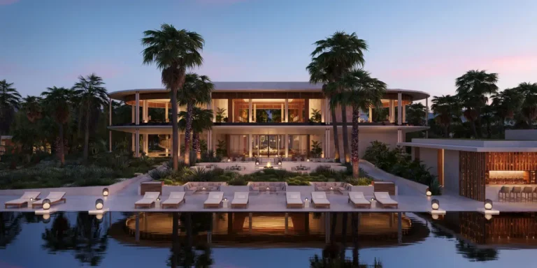 Luxury Travel 13 Luxury beachfront resort with palm trees, poolside loungers, and a modern two-story building at sunset