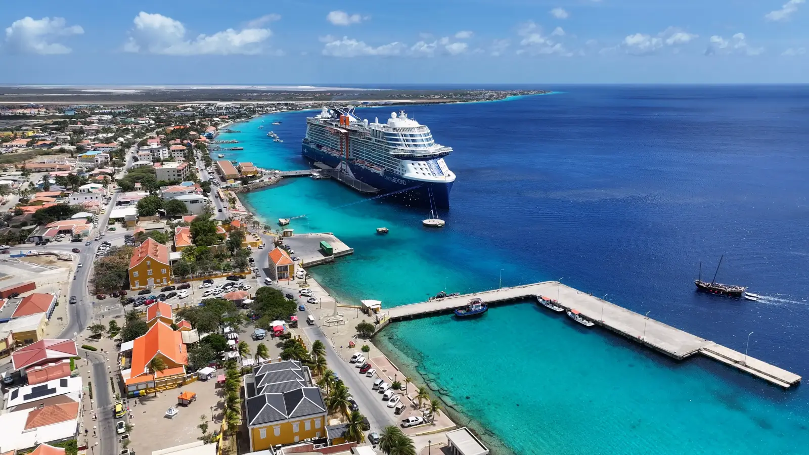 Cruise ship docked at the port of Kralendijk, Bonaire, with turquoise waters and colorful coastal town in view