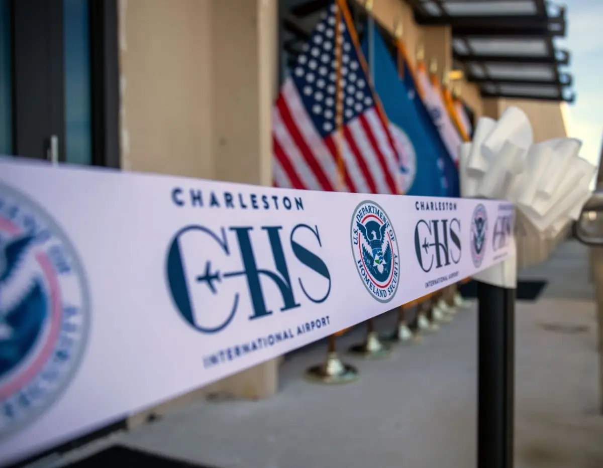 U.s. Customs And Border Protection Opens New Global Entry Enrollment Center At Charleston Airport 5 Ribbon with Charleston International Airport and U.S. Department of Homeland Security logos at Global Entry center opening.