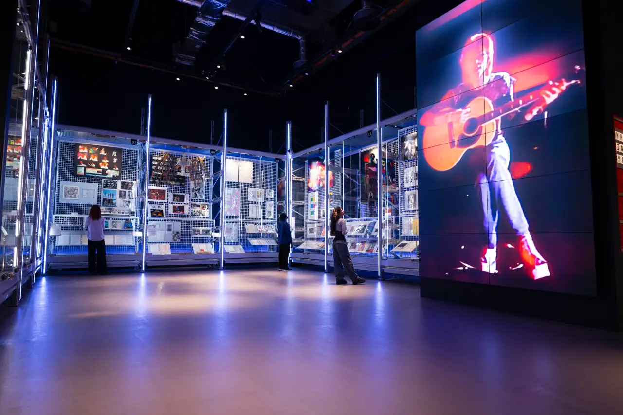 Get Up Close And Personal With David Bowie’s Legacy At London’s Victoria &Amp; Albert Museum 5 Visitors explore displays of David Bowie’s archive, with a large video projection of Bowie performing, at the V&A’s David Bowie Centre.