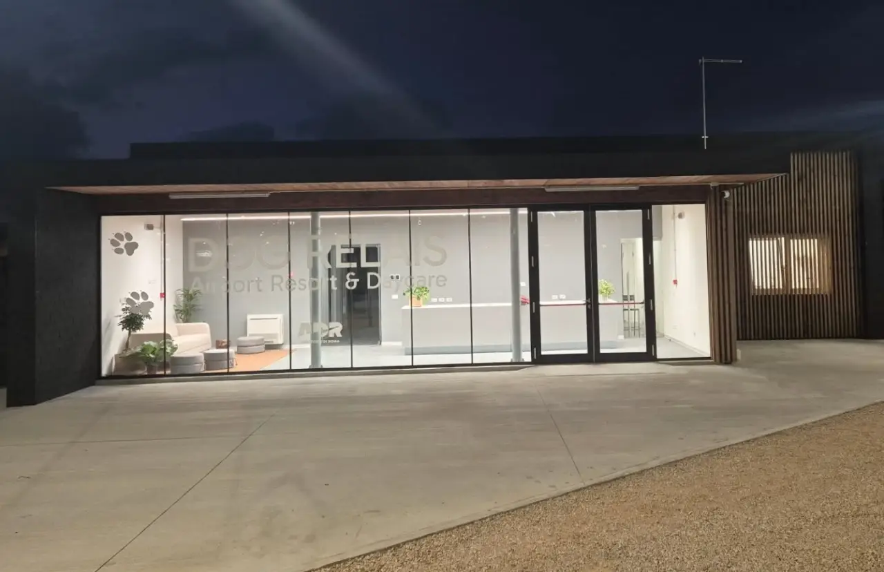 Front view of Dog Relais boarding and daycare facility at Rome Fiumicino Airport at night
