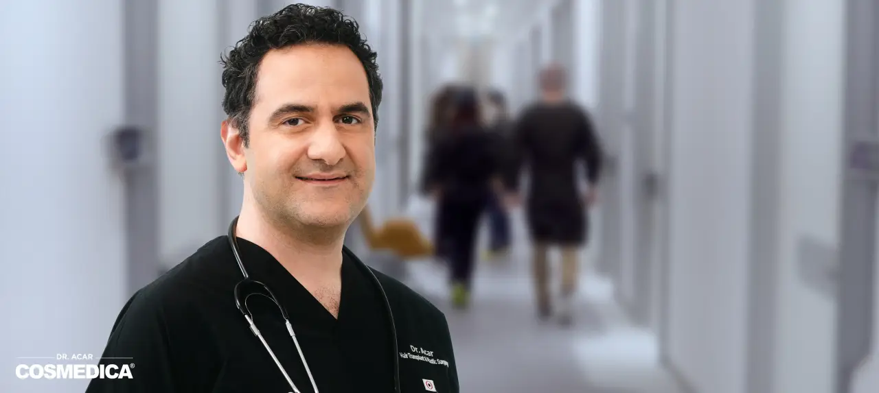 Dr. Levent Acar of Cosmedica Clinic standing in a modern medical hallway.