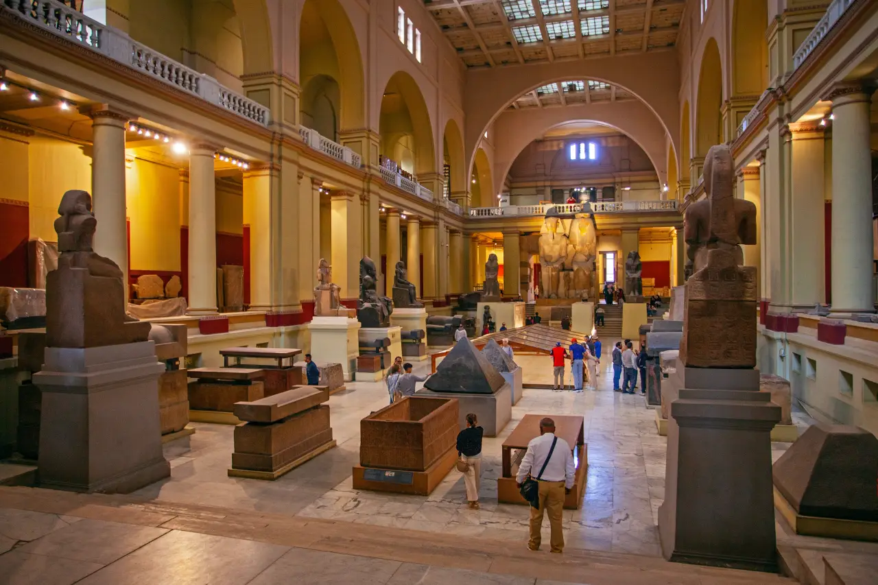 Visitors walk among ancient statues and artifacts inside the Egyptian Museum in Cairo.
