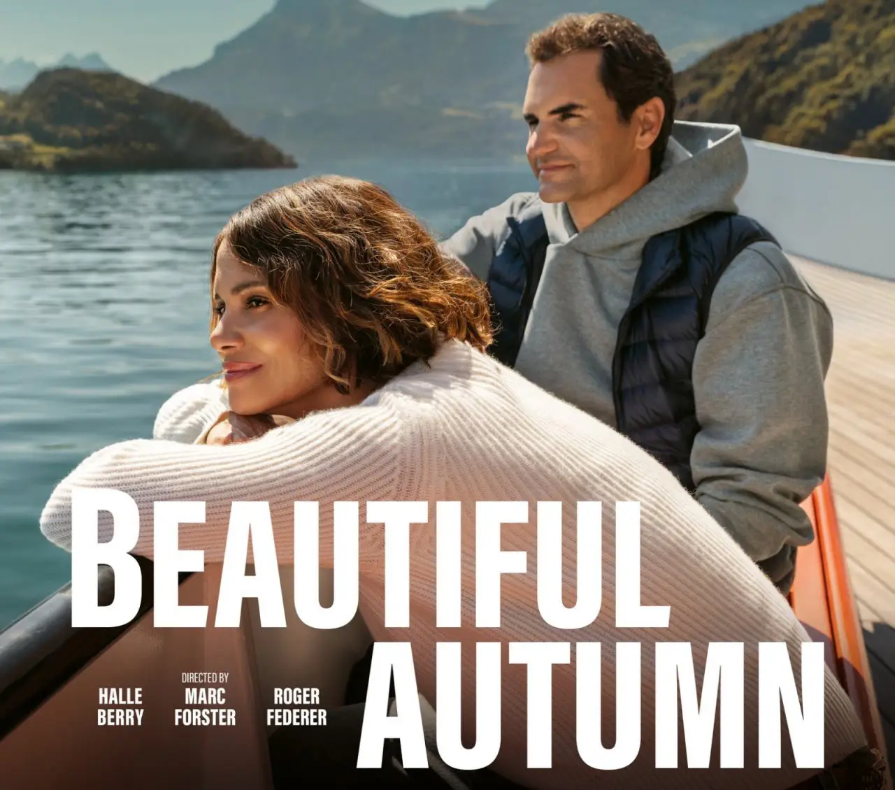 Roger Federer, Halle Berry Star In Swiss “Beautiful Autumn” Campaign 7 Roger Federer and Halle Berry in Switzerland Tourism’s “Beautiful Autumn” campaign, sitting on a boat with mountains in the background.