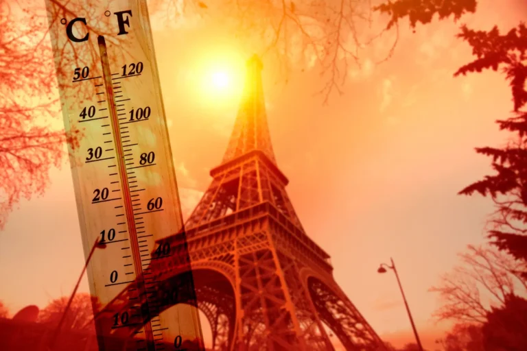 Tours 21 Eiffel Tower in Paris during a heatwave with thermometer showing extreme high temperatures.