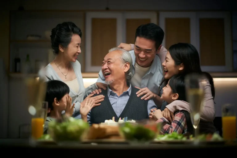 Japanese family celebrating with an elderly man, reflecting longevity and tradition.
