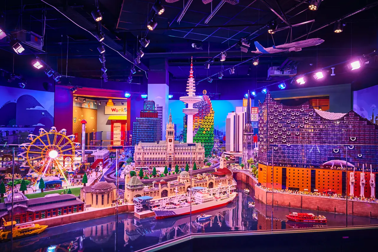 LEGO Discovery Centre city model display with ferris wheel, buildings, and airplane
