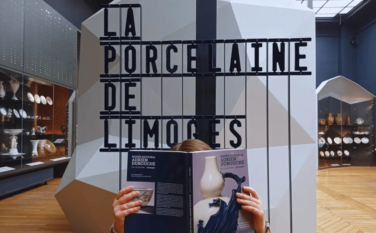 French Police Investigate High-Value Heist At Limoges Museum 2 Interior of Adrien Dubouché National Museum in Limoges with porcelain displays and a visitor holding a museum catalog.