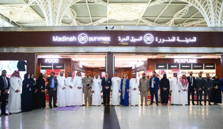 Officials and staff stand in front of the newly opened Madinah Duty Free store by Lagardère Travel Retail at Prince Mohammad bin Abdulaziz International Airport.