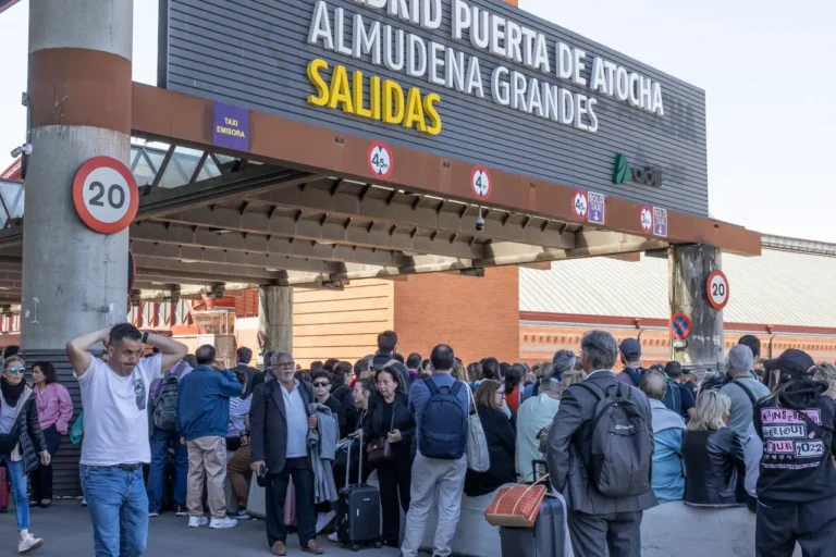 Spain Travel And Tourism News 21 Several people standing and waiting outside Atocha train station in Madrid.