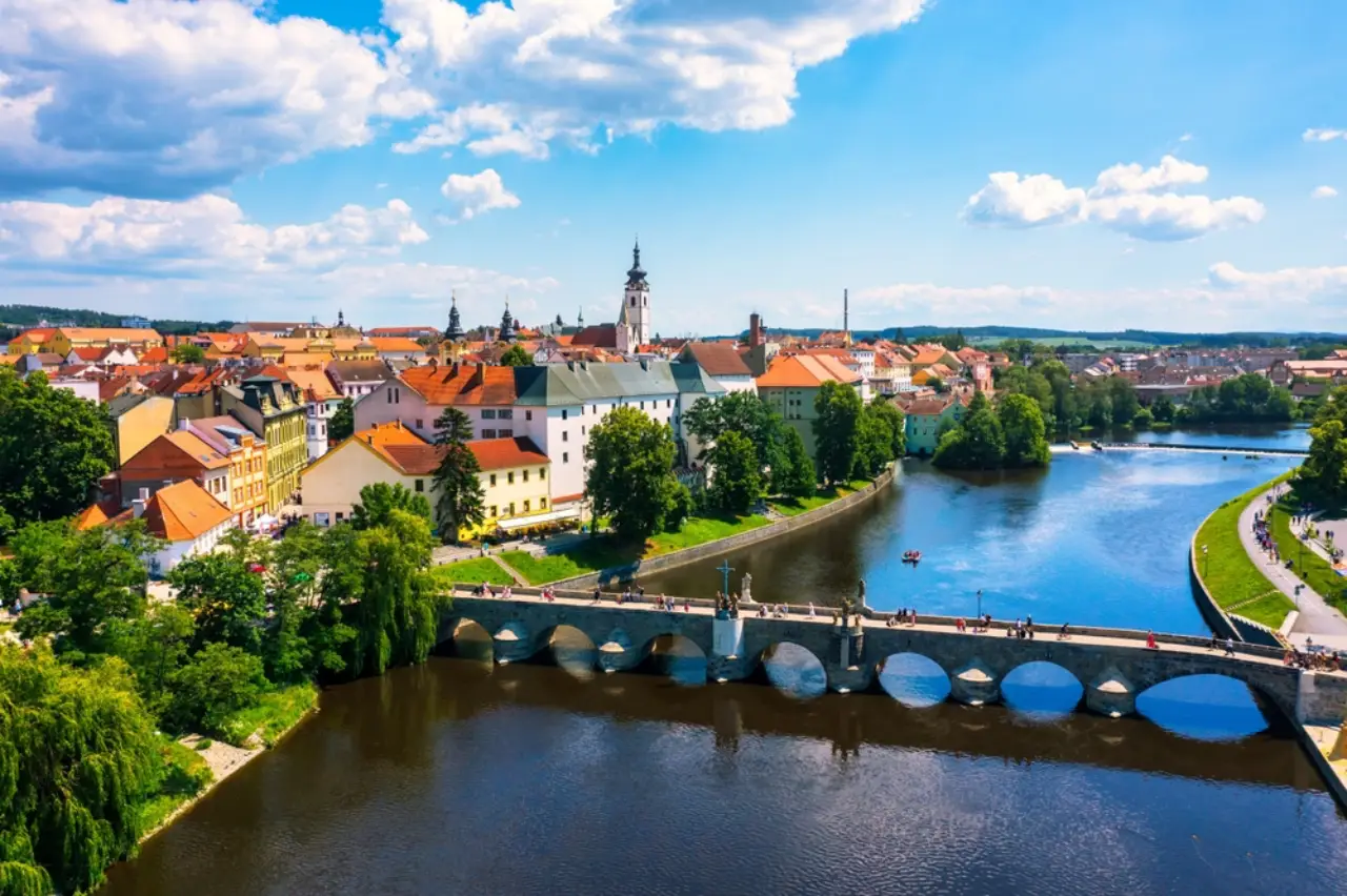 Aerial view of the medieval town of Písek in South Bohemia, with the historic Písek Stone Bridge crossing the Otava River in the Czech Republic.