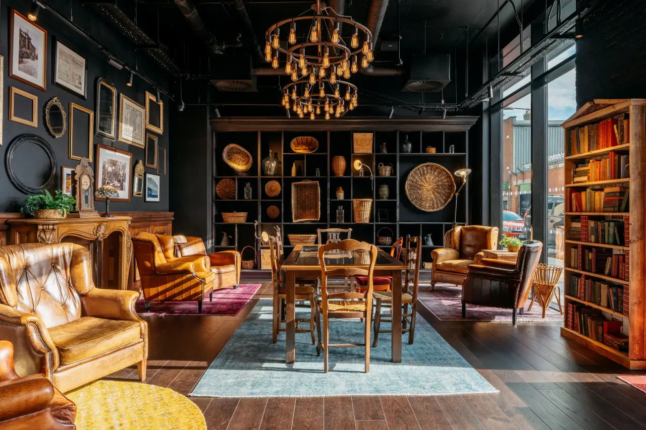 Cozy lounge area at Ruby Hotel with vintage leather chairs, bookshelves, and warm lighting in Dublin.