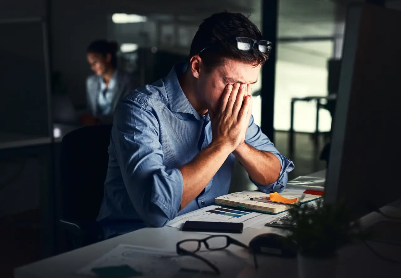 Who Warns Over 1 Billion People Affected By Mental Health Disorders Worldwide 2 Stressed man in office holding his face in his hands while working late at a computer