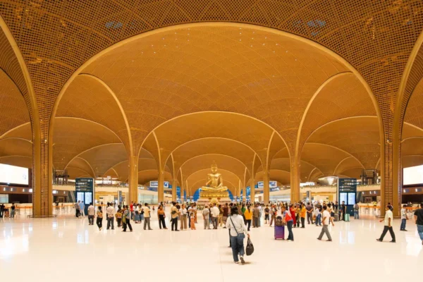 Interior of Techo International Airport with Buddha statue and bamboo-patterned arches