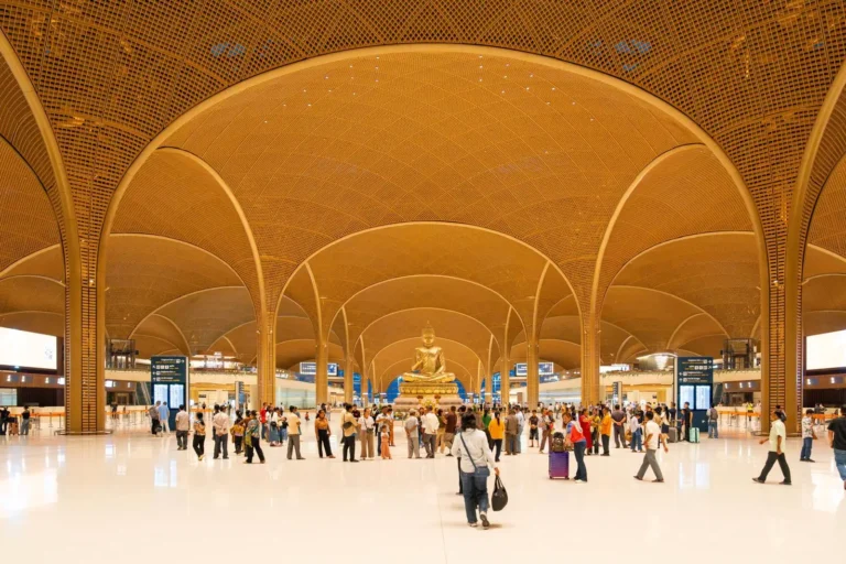 Interior of Techo International Airport with Buddha statue and bamboo-patterned arches