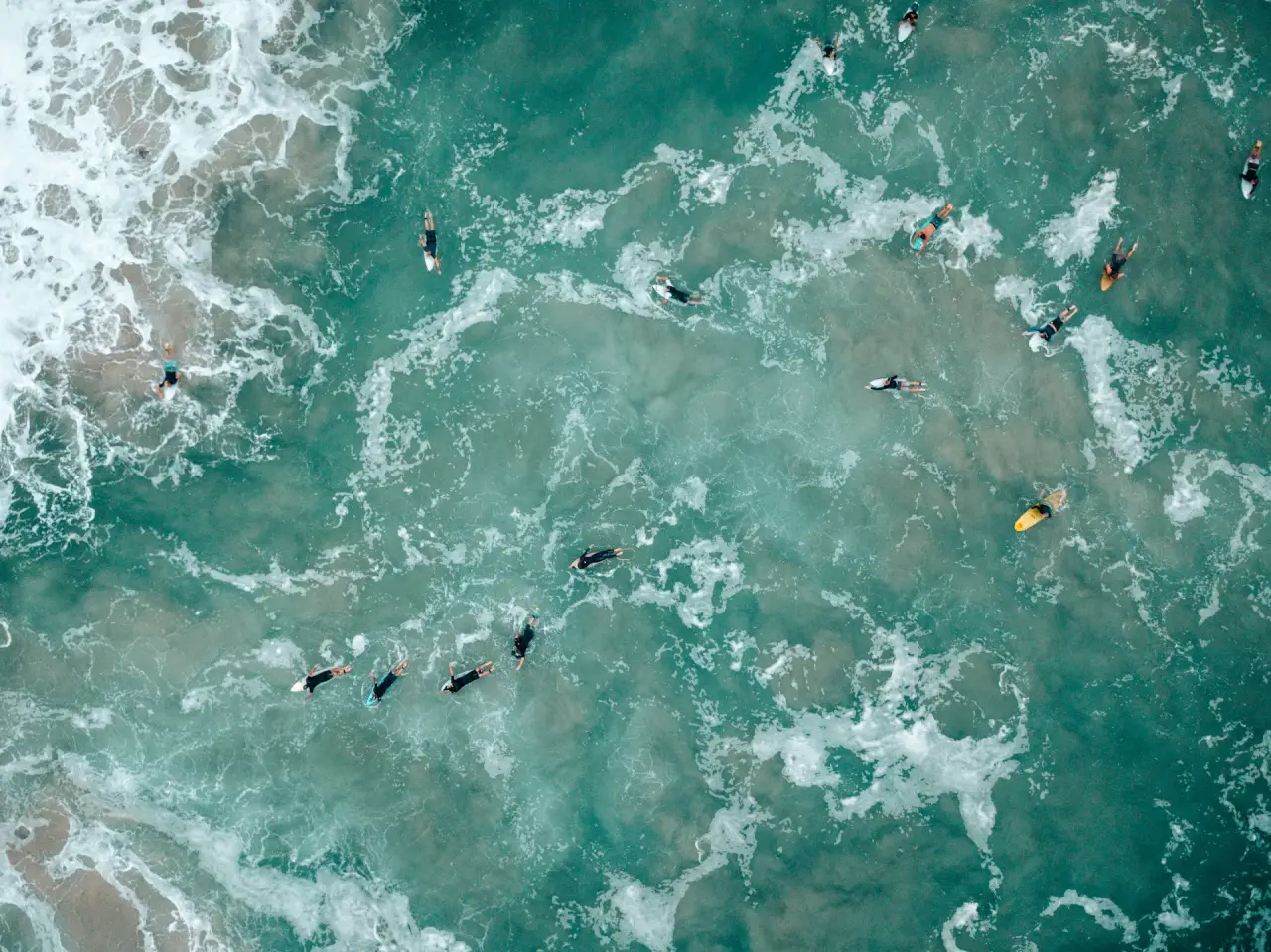 Gold Coast Living Unpacked: Beach, Bush and Boutique 1 Aerial view of surfers on a beach at Gold Coast, Australia