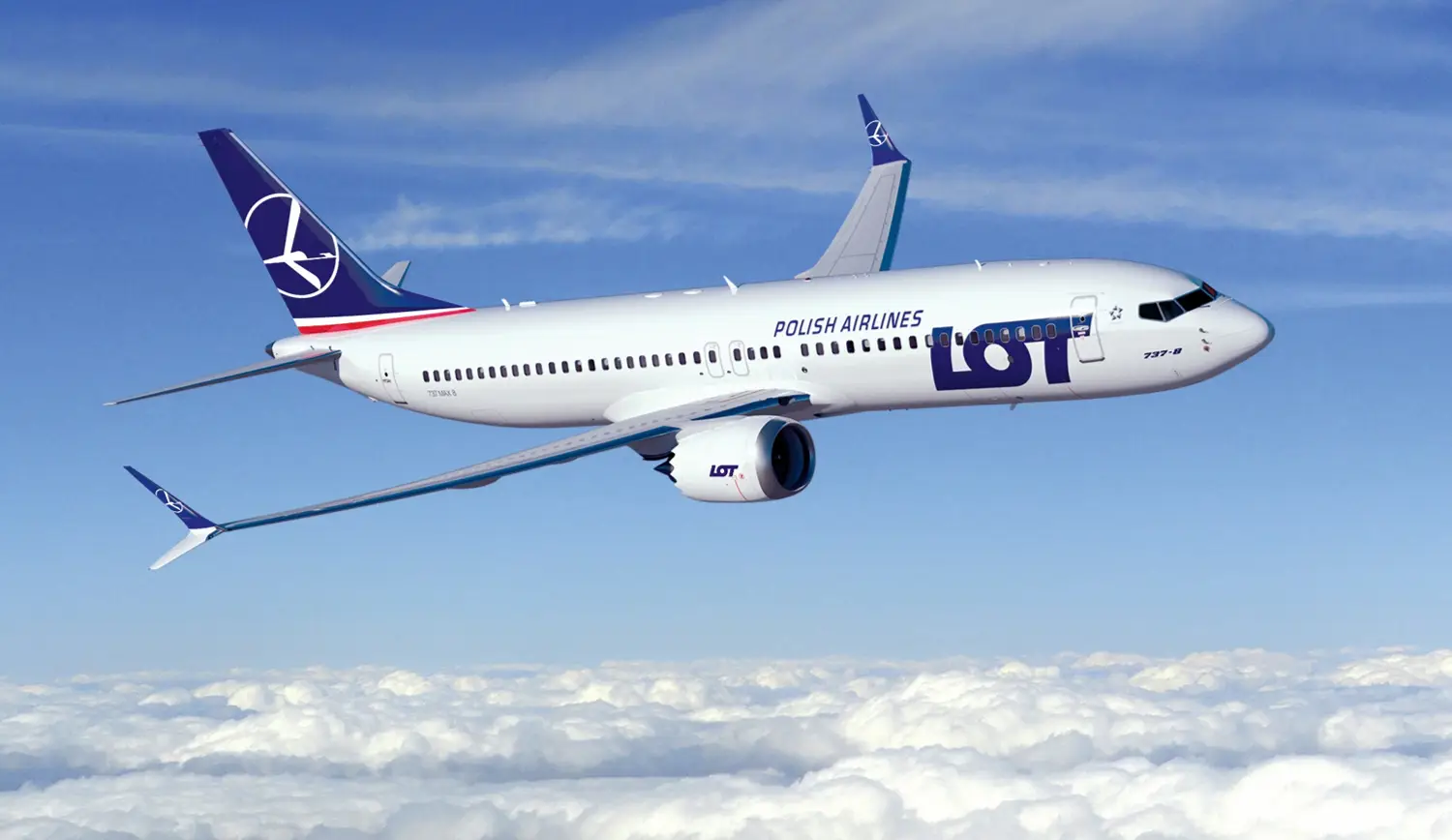 LOT Launches Bologna–Warsaw Flights 4 LOT Polish Airlines Boeing 737 MAX 8 aircraft flying above the clouds under a clear blue sky.